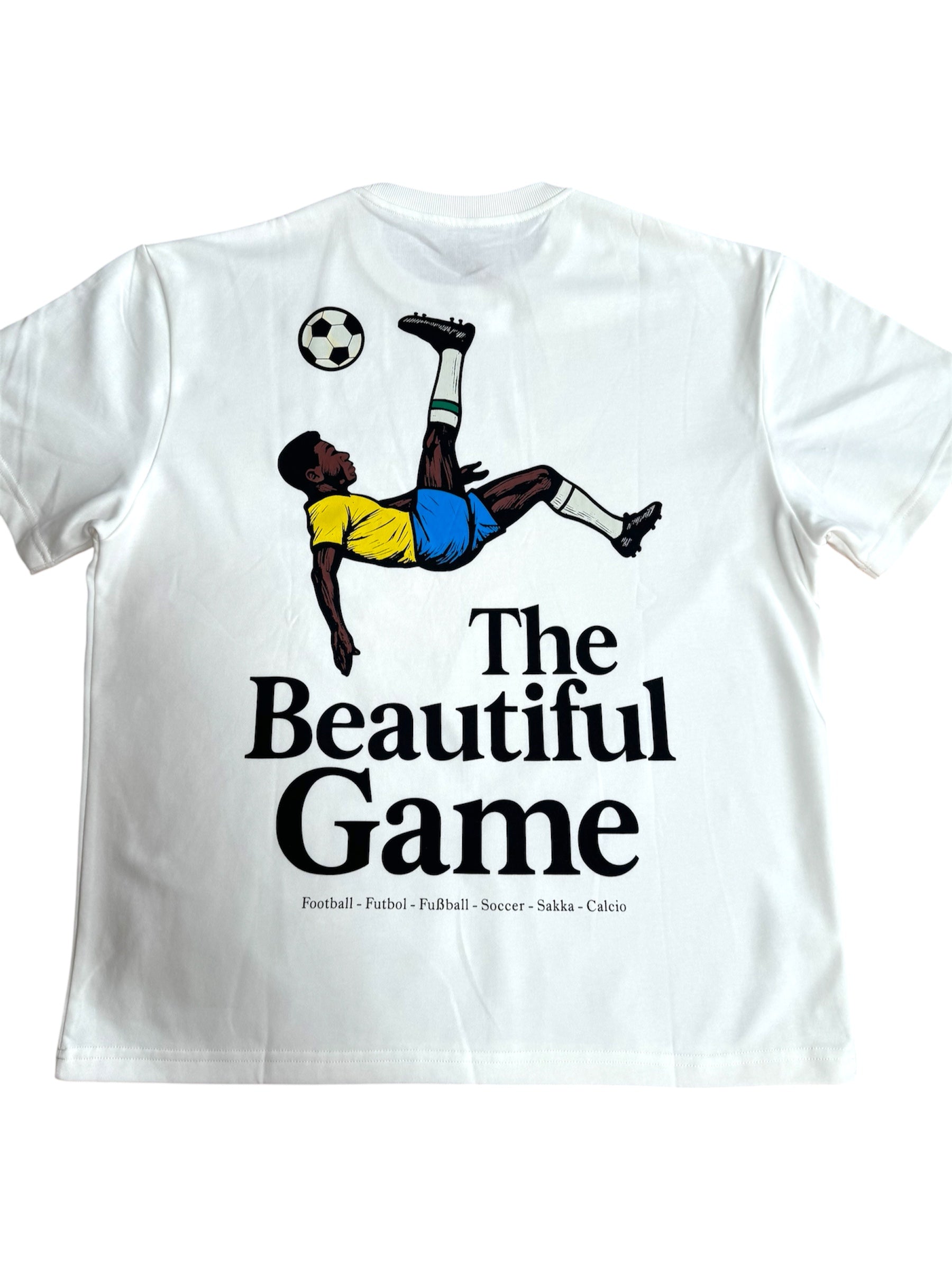 White t-shirt with a graphic of a soccer player and 'The Beautiful Game' text on a white background